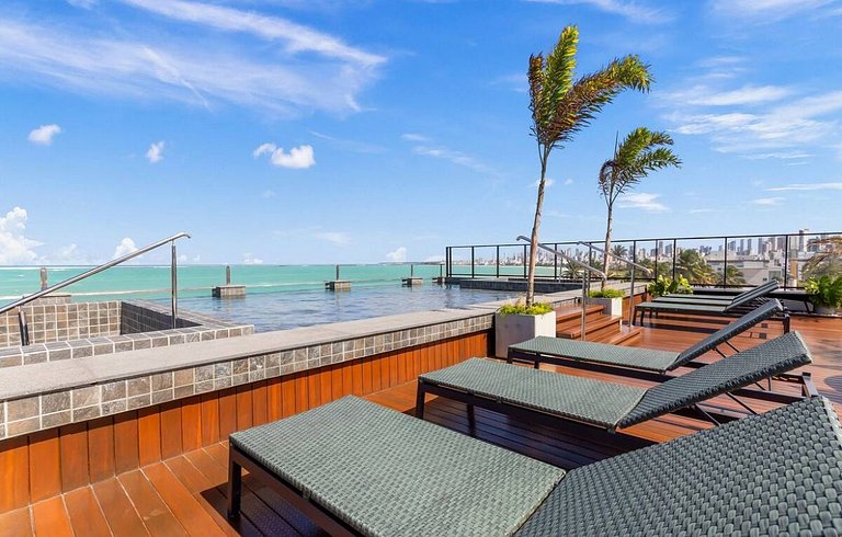 Flat pé na areia: acorde de frente pro mar