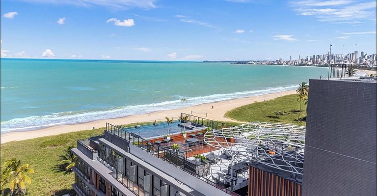 Flat pé na areia: acorde de frente pro mar